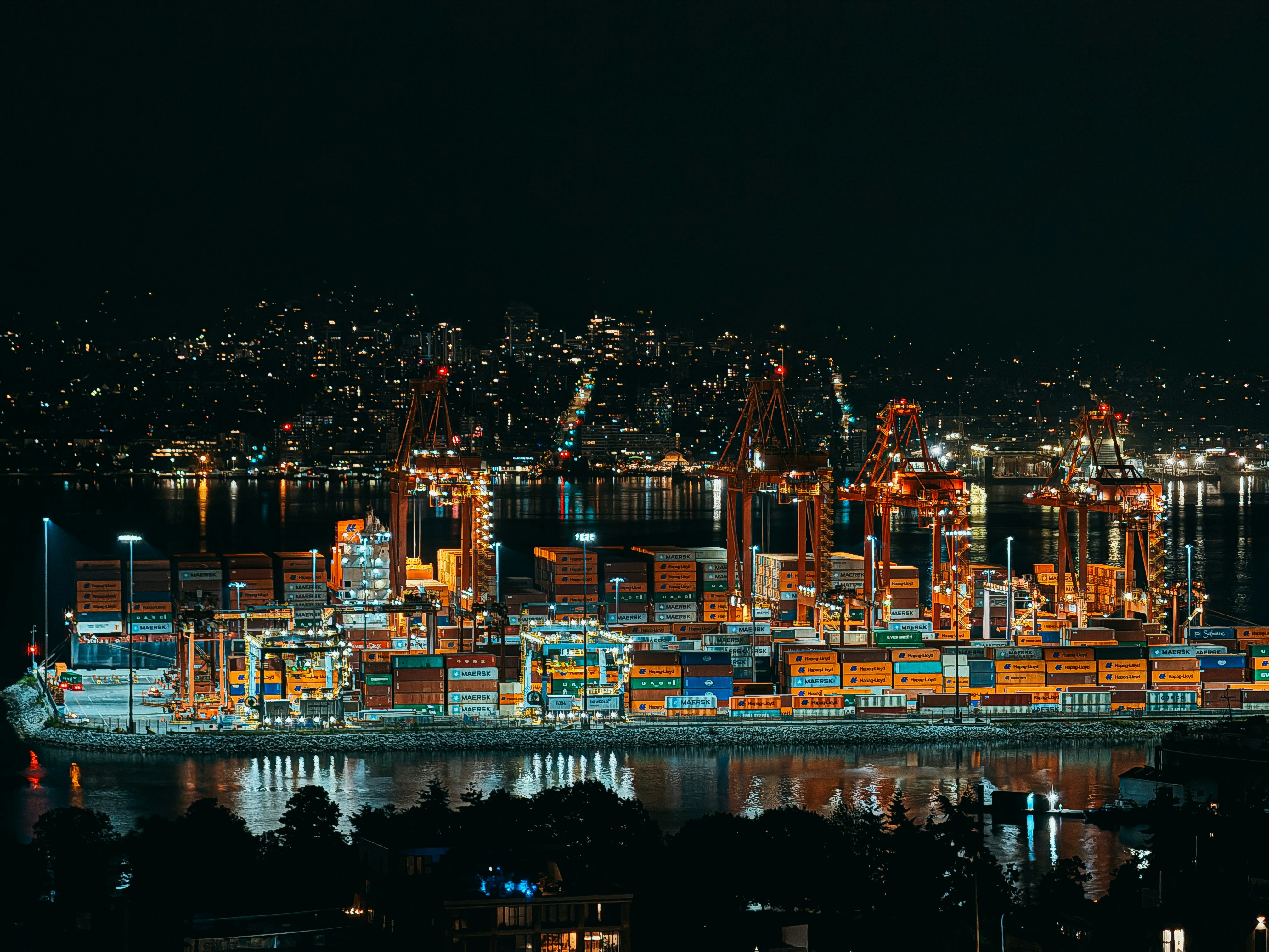A massive backlog of shipping containers at a port at night